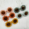 Load image into Gallery viewer, Assorted flower-shaped sunglasses with round lenses in peach, orange, mustard, and mint green frames, displayed on a textured white surface.
