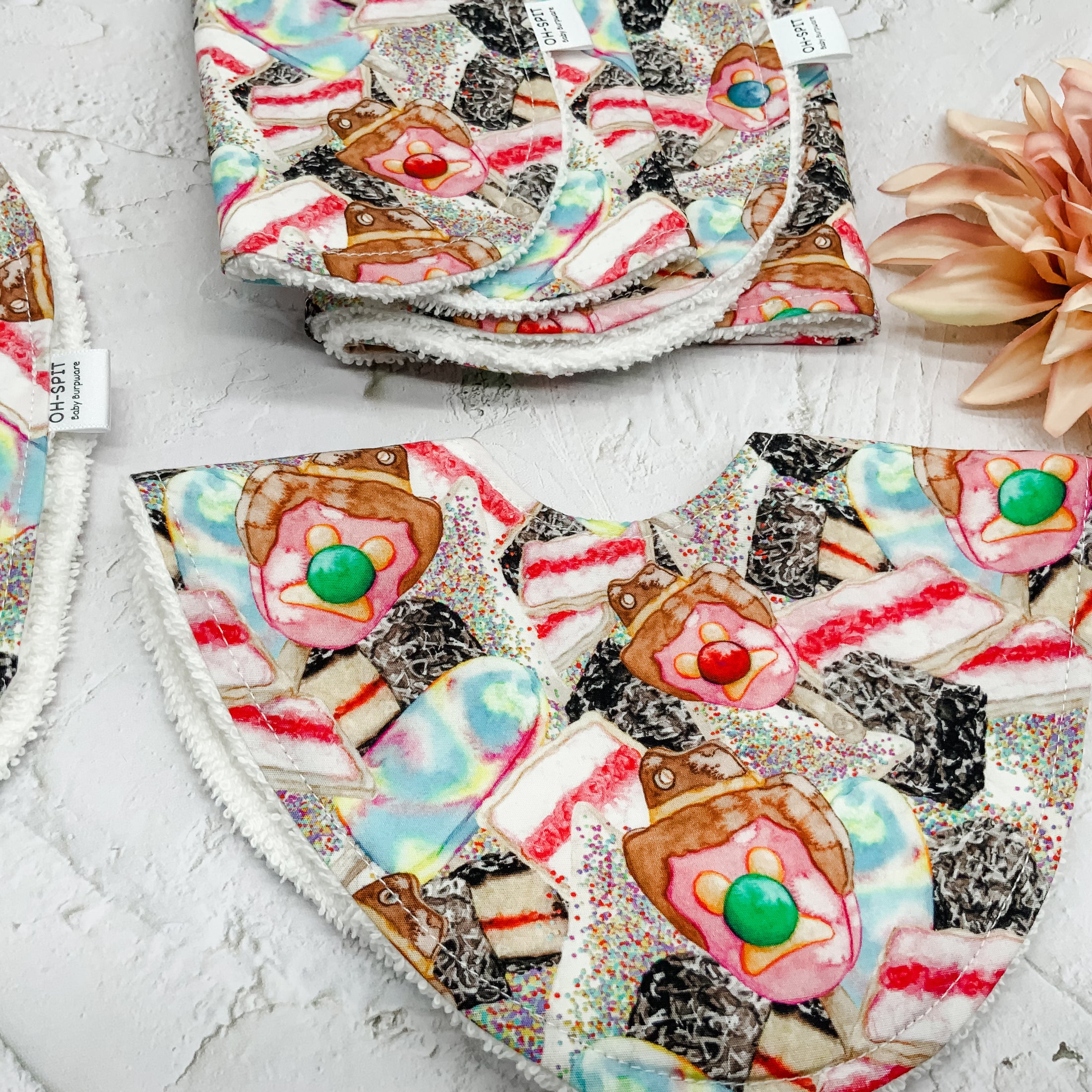 Australian Sweet Treats Dribble Bib – Handmade baby bib featuring a fun print of classic Aussie desserts. Designed with a soft cotton front and absorbent towelling backing for mess-free mealtimes.